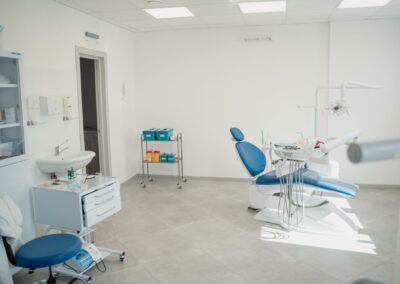 Bright and clean dental clinic interior showcasing a dental chair and equipment.