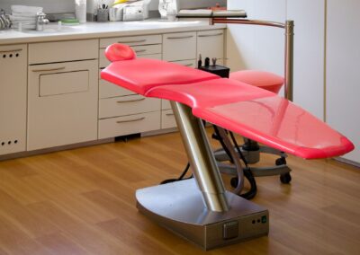 Bright modern dental chair in a well-organized dentist's clinic room.